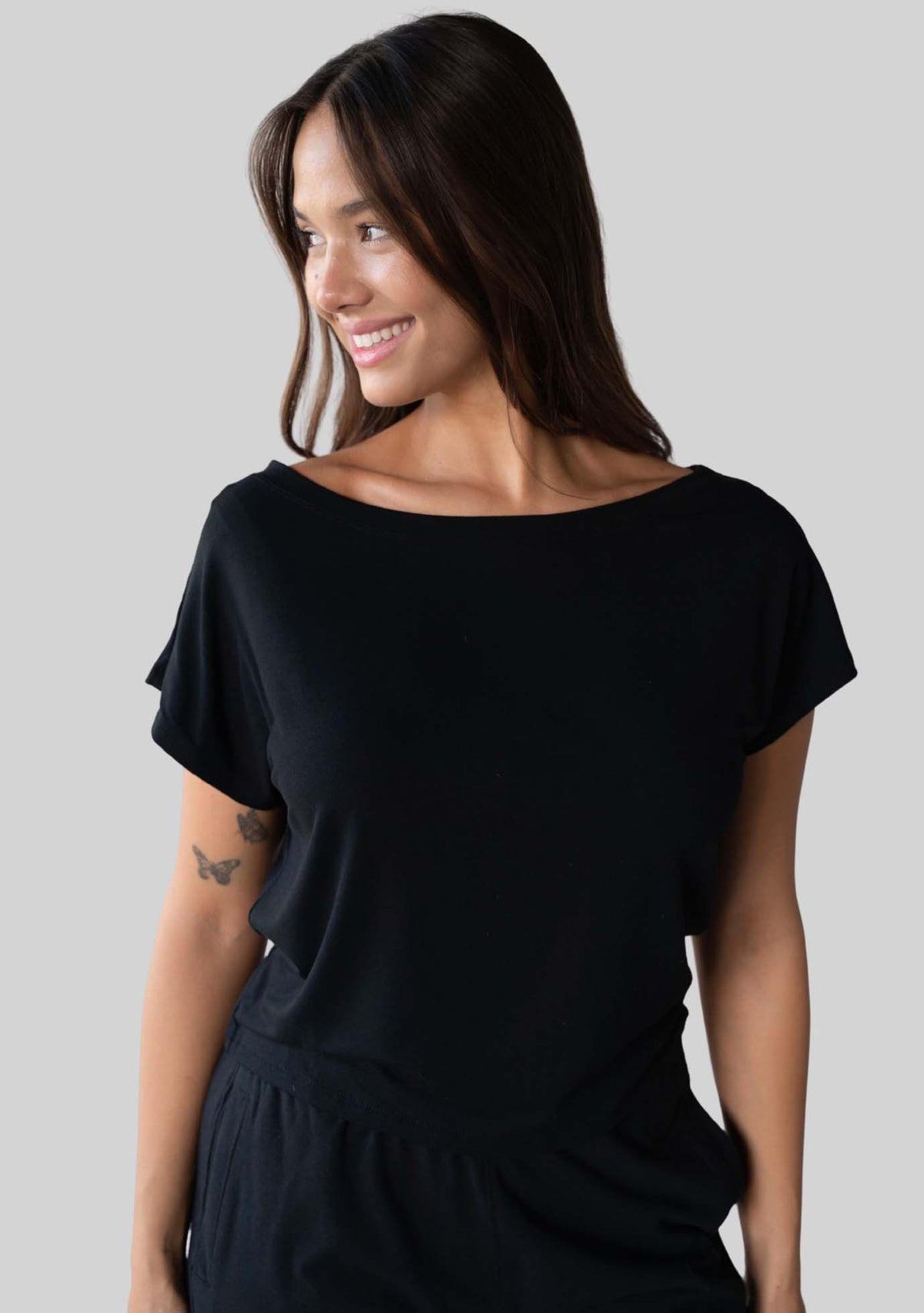 Model wearing the JALA Dreamer Dolman Tee in Black, styled front view