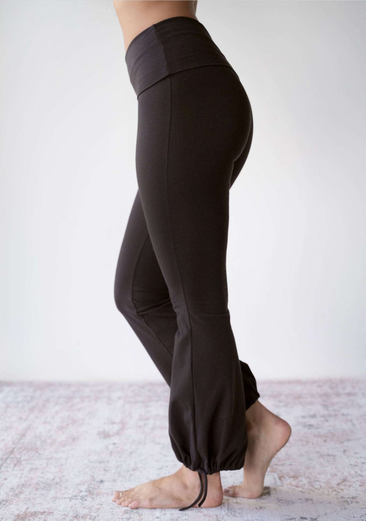 Side view of the JALA Nama Balloon Flare Legging in Chocolate showing the high waist and flared leg