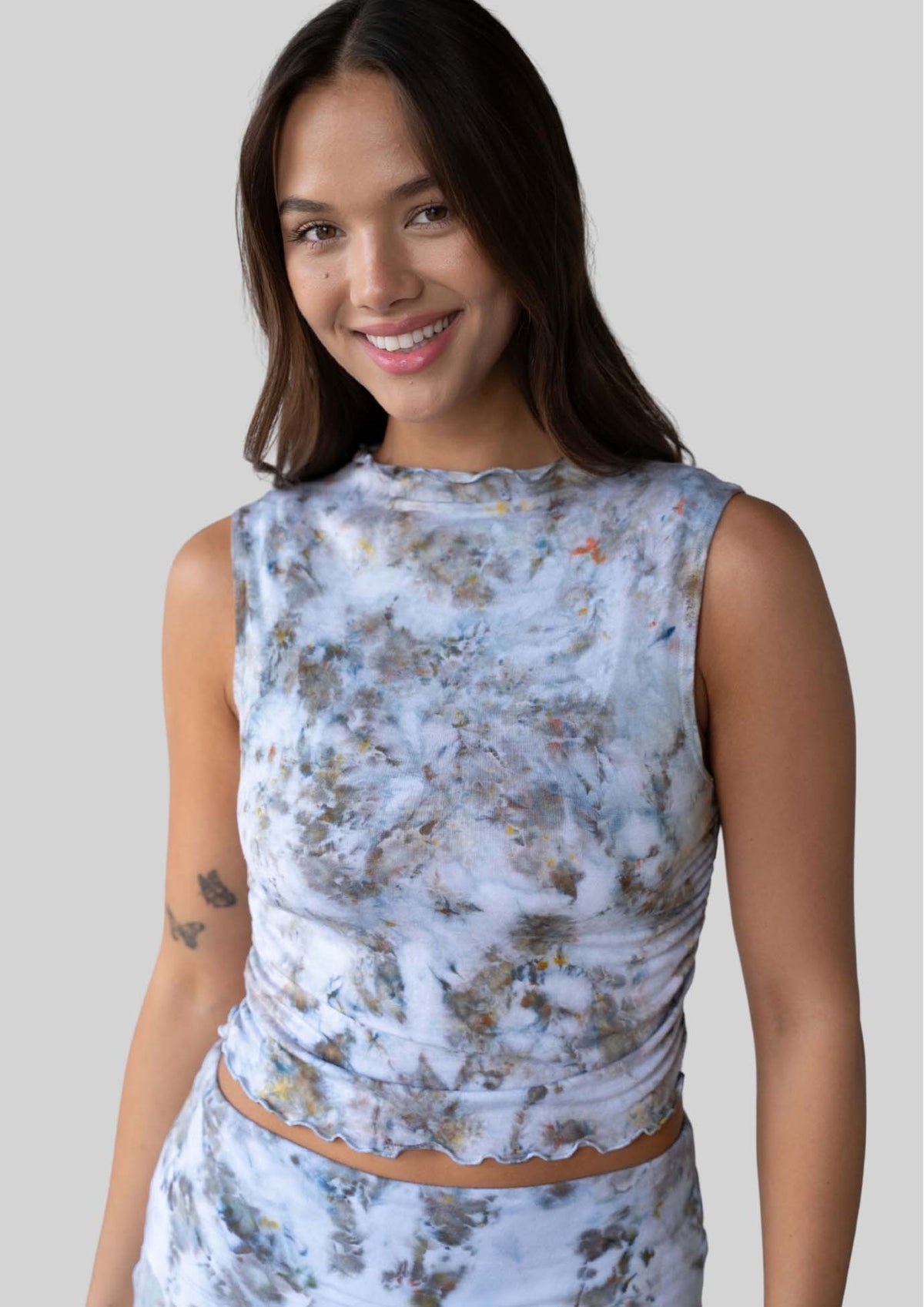 Model wearing the JALA Whisper Tank in Morel with lettuce edge hem and high neckline, front view