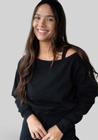 Model wearing the JALA Aela Top in Black, styled off the shoulder, front view