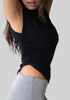 Side view of the JALA Align Tee in Black showing the side shirring