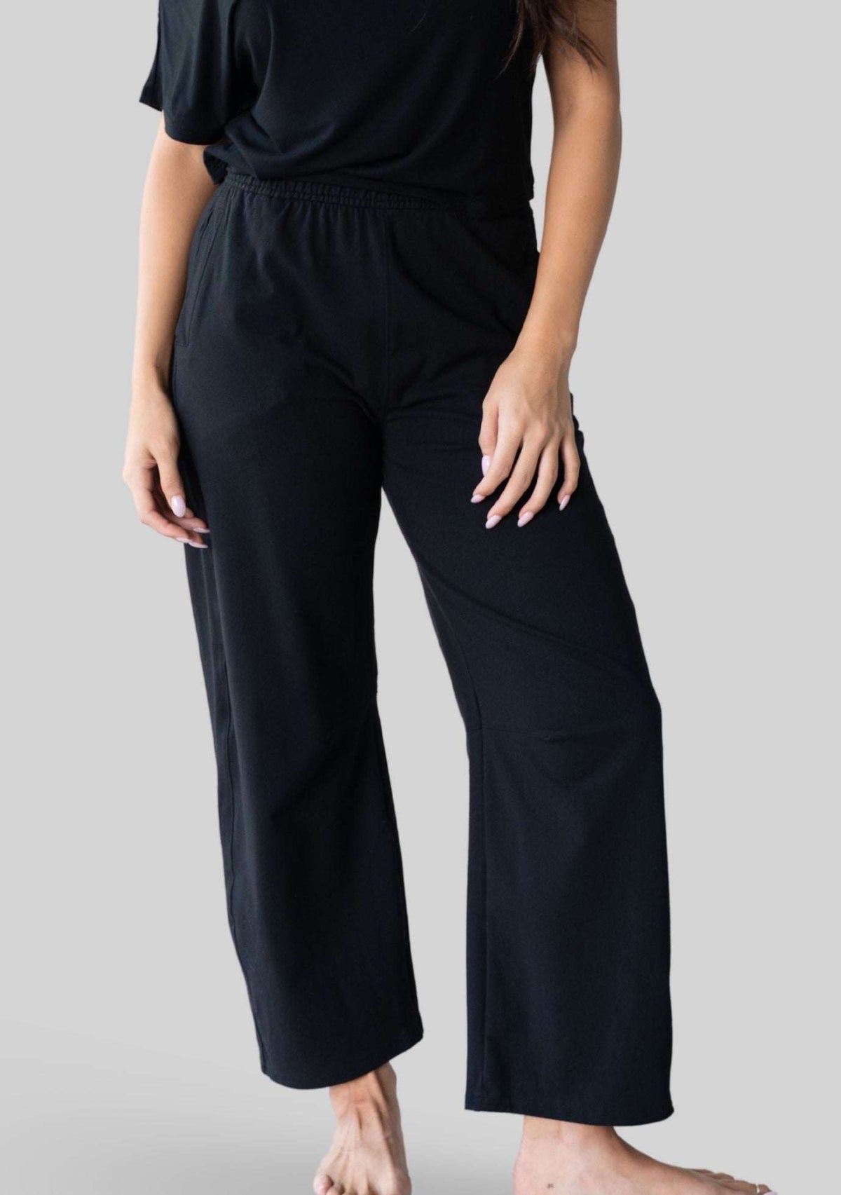 Front view of the JALA Bliss Barrel Pant in Black showing the barrel leg shape