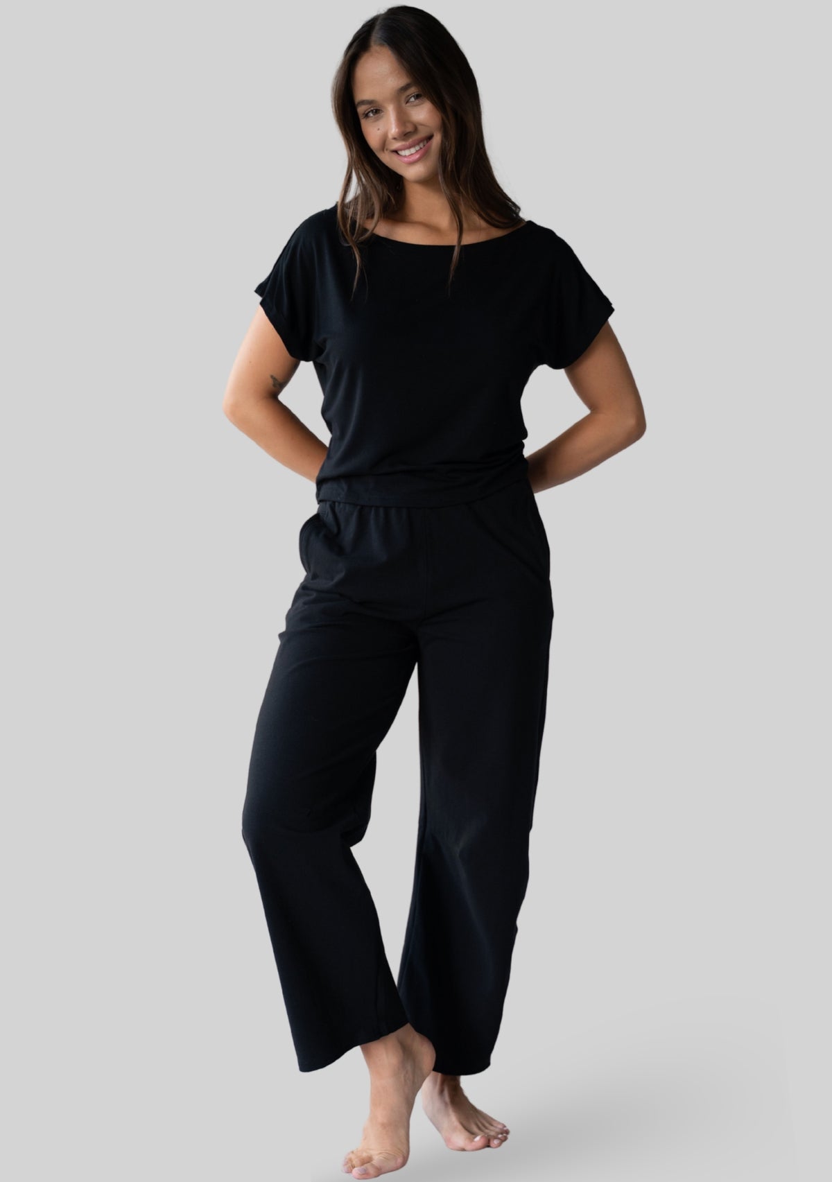 Model wearing the JALA Bliss Barrel Pant in Black, full length lifestyle shot