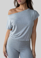 Model wearing the JALA Dreamer Dolman Tee in Heather Grey with soft dolman sleeves, front view
