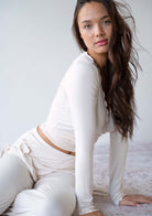 Model wearing the JALA Kira Wrap Top in Cream, lifestyle shot