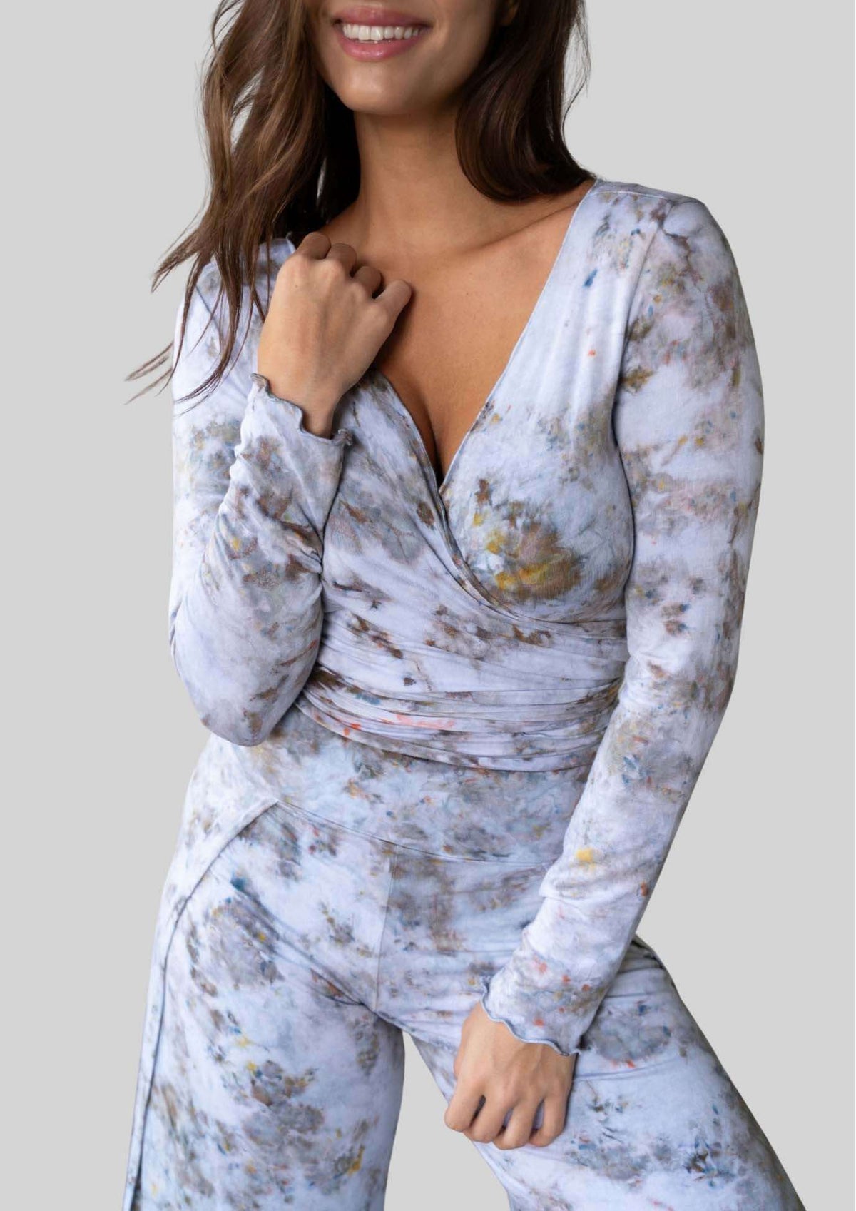 Model wearing the JALA Kira Wrap Top in Morel with delicate merrow edges, front view