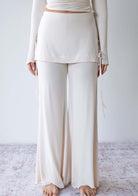 Model wearing the JALA Luna Pant in Cream with low rise waistband and flowy fit, front view