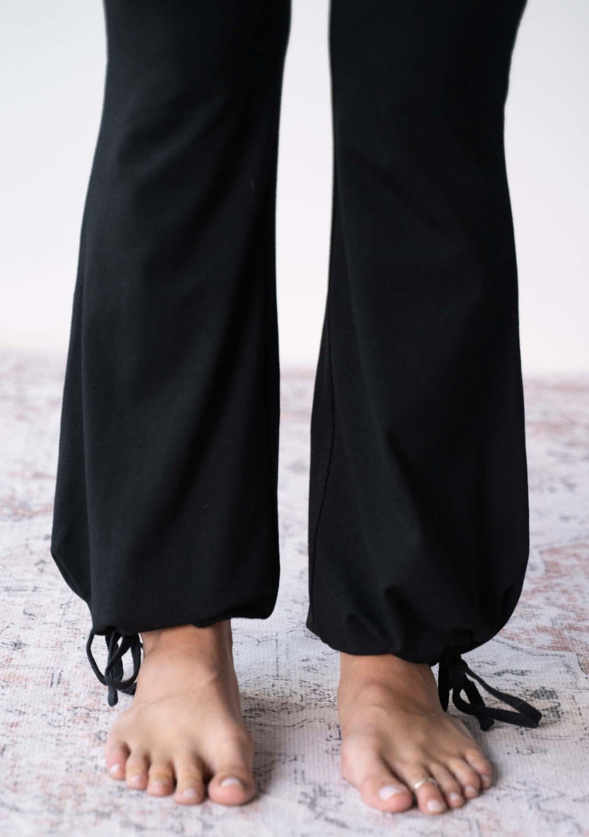 Close up of the tie ankle balloon hem on the JALA Nama Balloon Flare Legging in Black