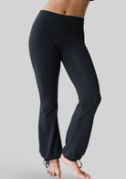 Angled side view of the JALA Nama Balloon Flare Legging in Black