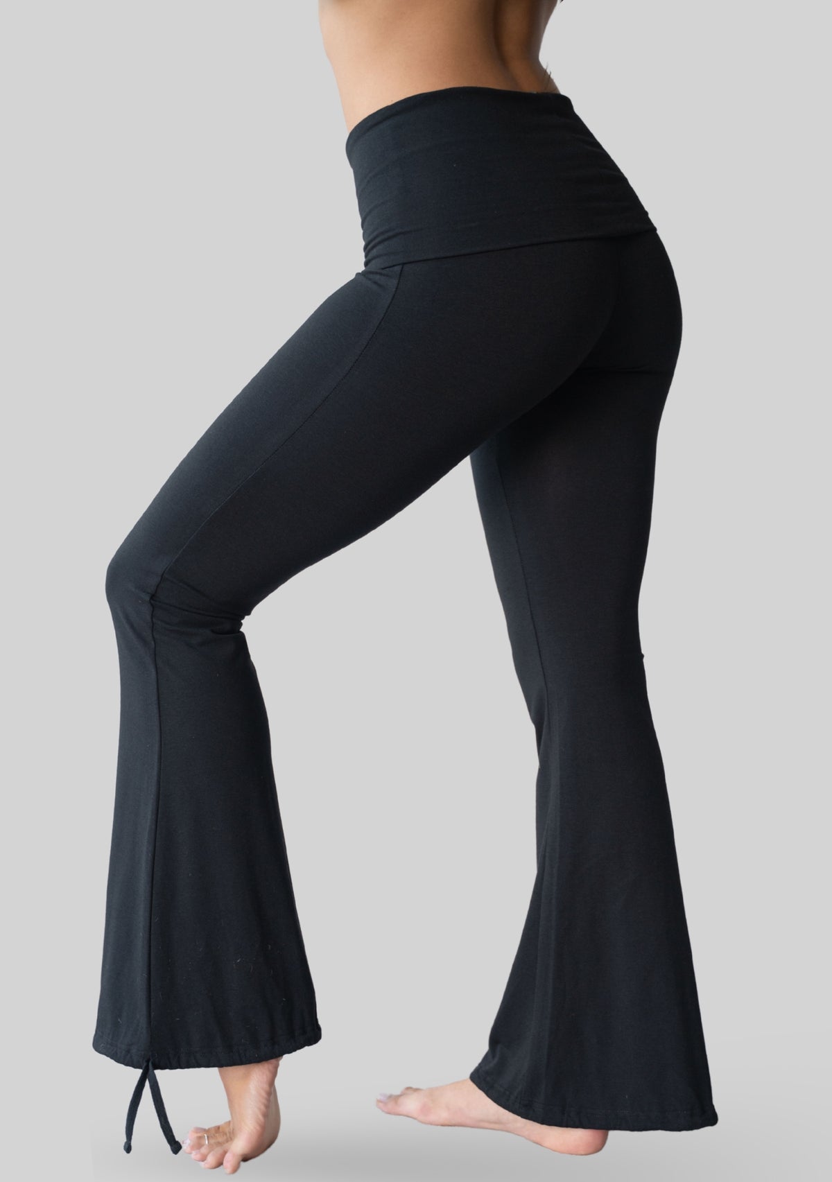 Side view of the JALA Nama Balloon Flare Legging in Black showing the flared leg